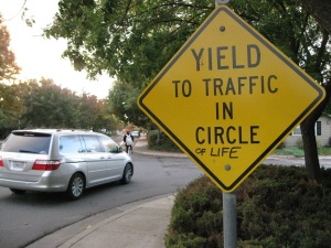 Sign saying "Yield to Traffic in Circle of Life"